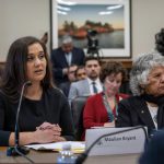 Maulian Bryant sitting at a desk speaking to a Congressional committee