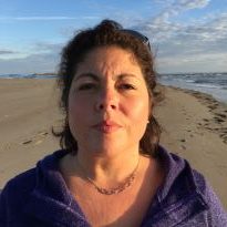 Photo of Monica Castellanos standing on a beach