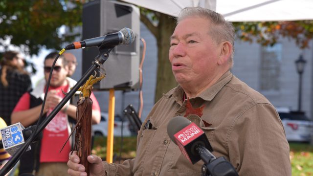 Mi'kmaq Nation Vice Chief Robert Silliboy addressed a crowd of more than 200 people at the State House. Photo: Anne Henshaw Mi'kmaq Nation Vice Chief Robert Silliboy standing before microphones