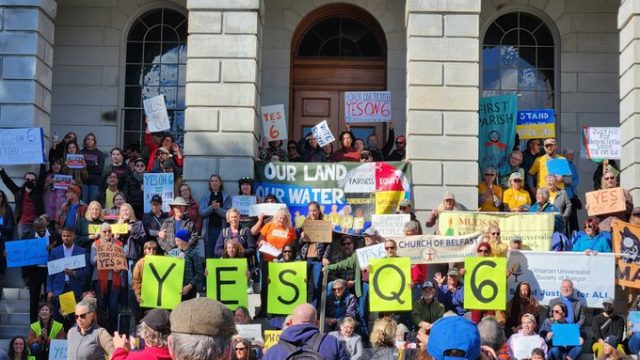 Question 6 would require the state of Maine to print the entire state constitution, including a section on tribal treaties that has been excluded for more than 100 years. Photo: Rob Laraway Group of people standing in front of Maine State House with signs Yes on Q6