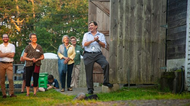 Senate President Troy Jackson laughs at remarks at the event. Senate President Troy Jackson laughs and claps hands with a small crowd looking on